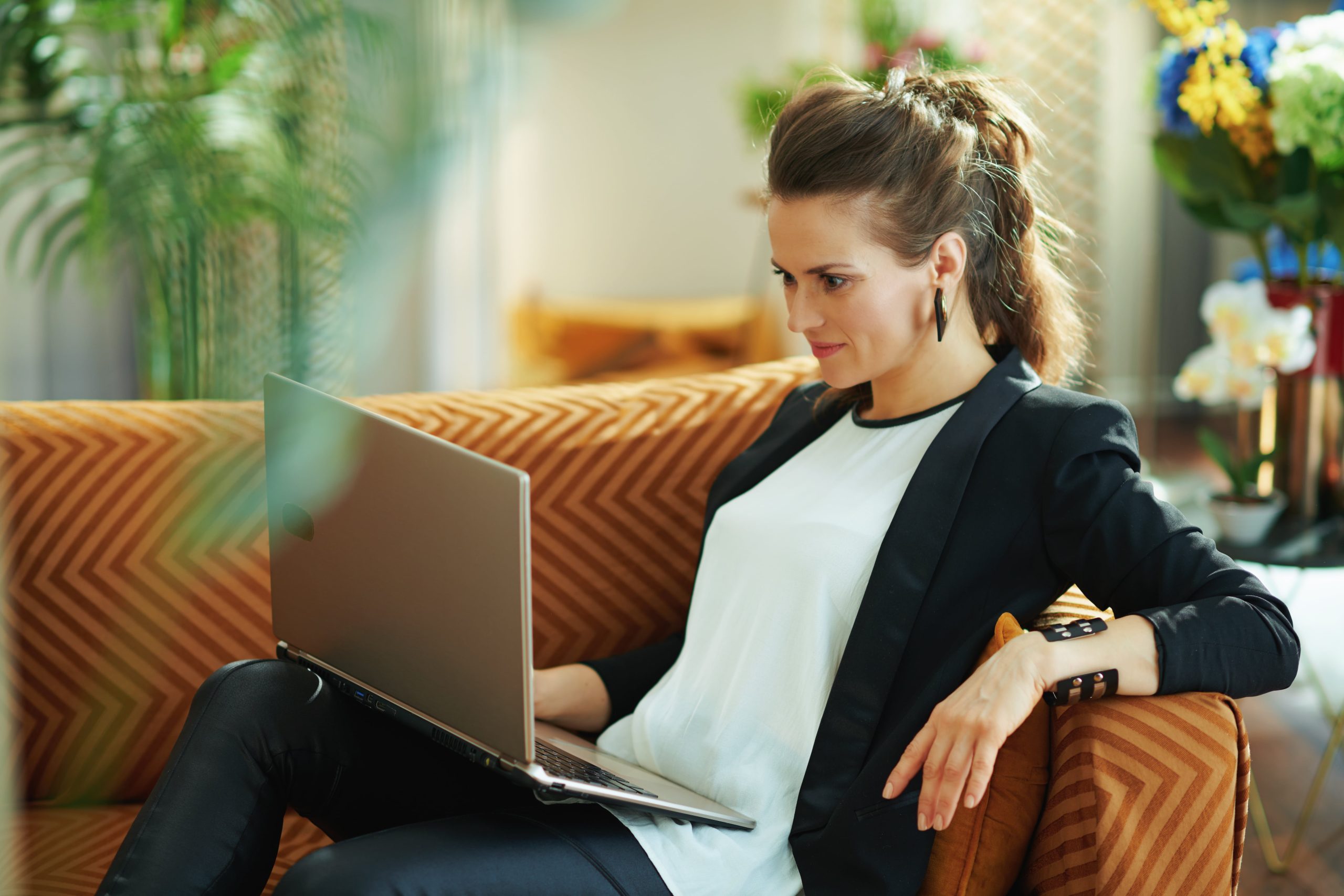 woman looking at laptop screen with retail internet banking platform